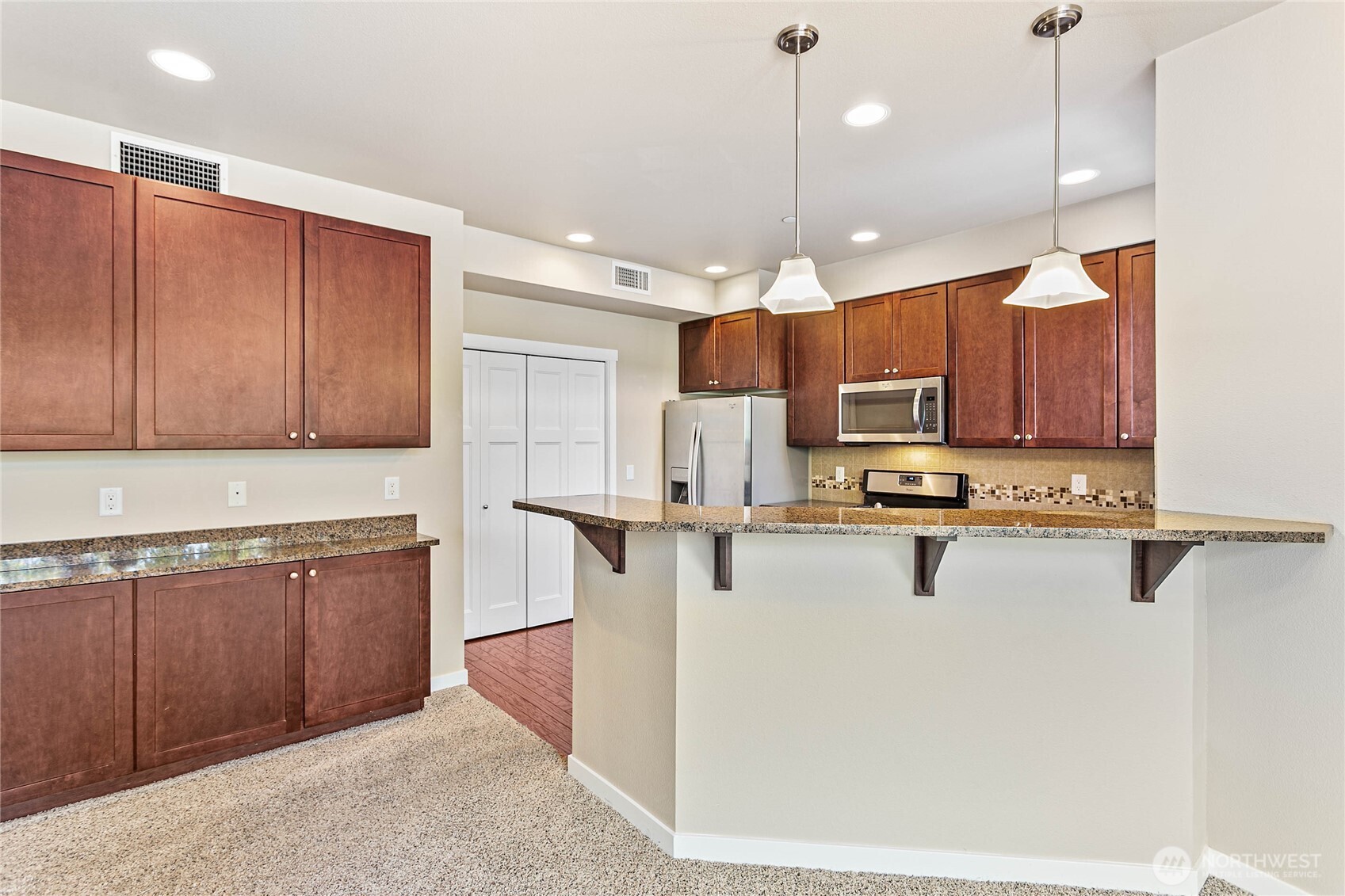 8780 Depot Road, Unit 207 Lynden, WA 98264 - Photo 11 of 37 a kitchen with a refrigerator a sink and cabinets