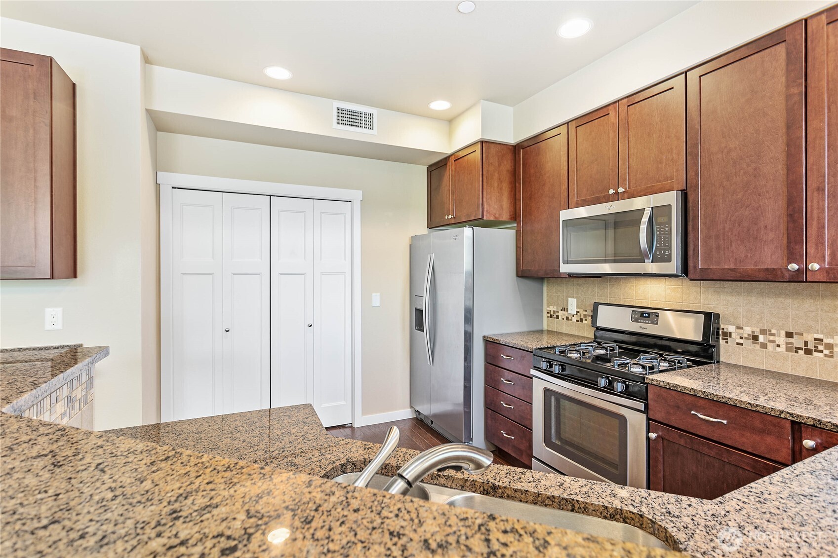 8780 Depot Road, Unit 207 Lynden, WA 98264 - Photo 12 of 37 a kitchen with stainless steel appliances granite countertop a refrigerator stove and sink