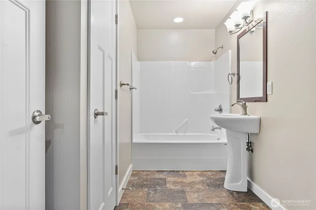 a bathroom with a sink a shower and a mirror