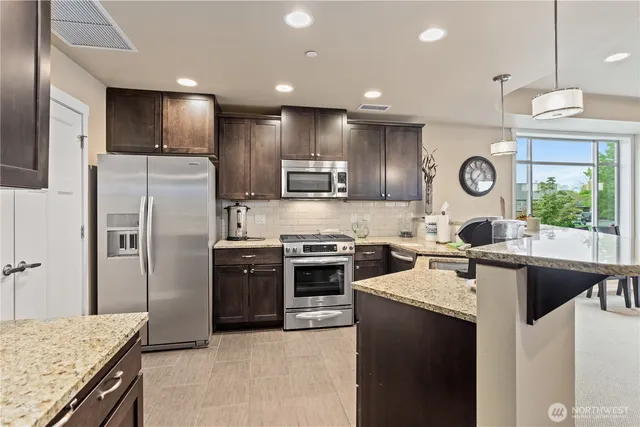 a view of a chairs and table in the balcony