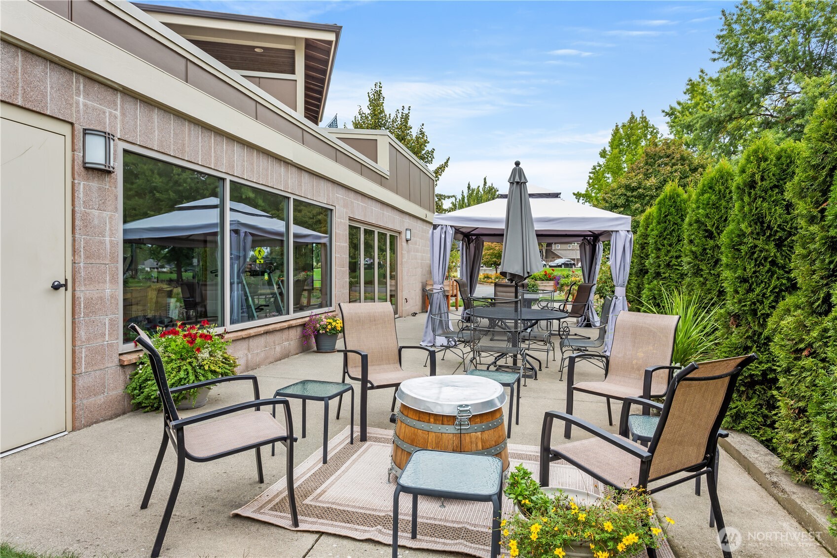 8780 Depot Road, Unit 207 Lynden, WA 98264 - Photo 35 of 37 a view of a patio with table and chairs and potted plants