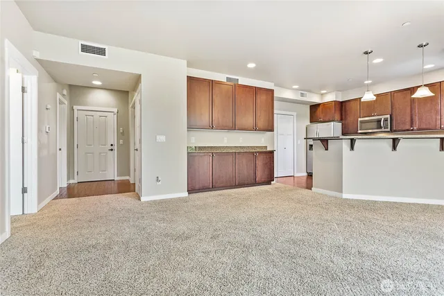 a view of kitchen with refrigerator and a sink
