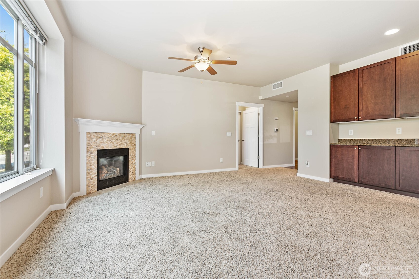 8780 Depot Road, Unit 207 Lynden, WA 98264 - Photo 6 of 37 a view of empty room with a fireplace and fan