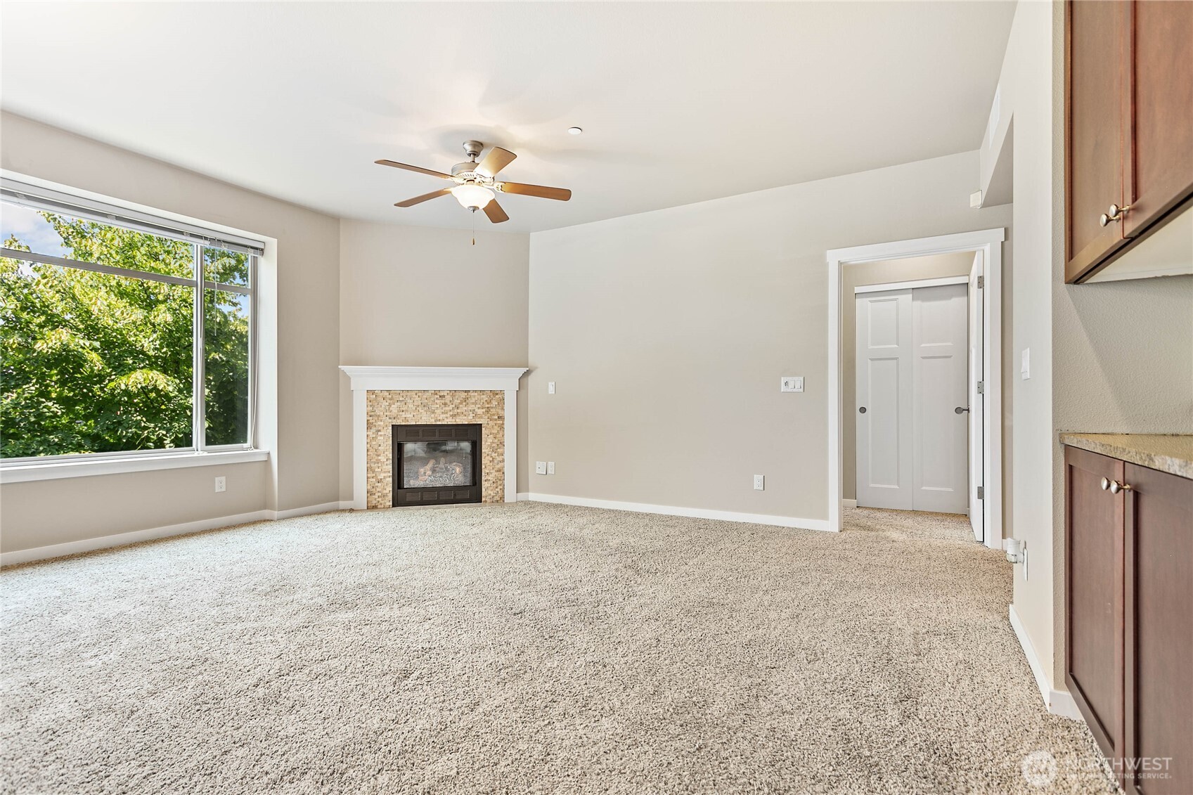 8780 Depot Road, Unit 207 Lynden, WA 98264 - Photo 7 of 37 a view of a livingroom with a fireplace and ceiling fan