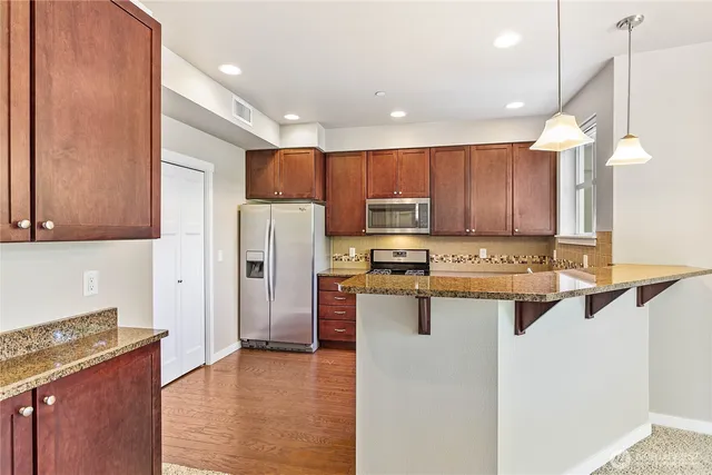a view of a kitchen with a sink and chandelier