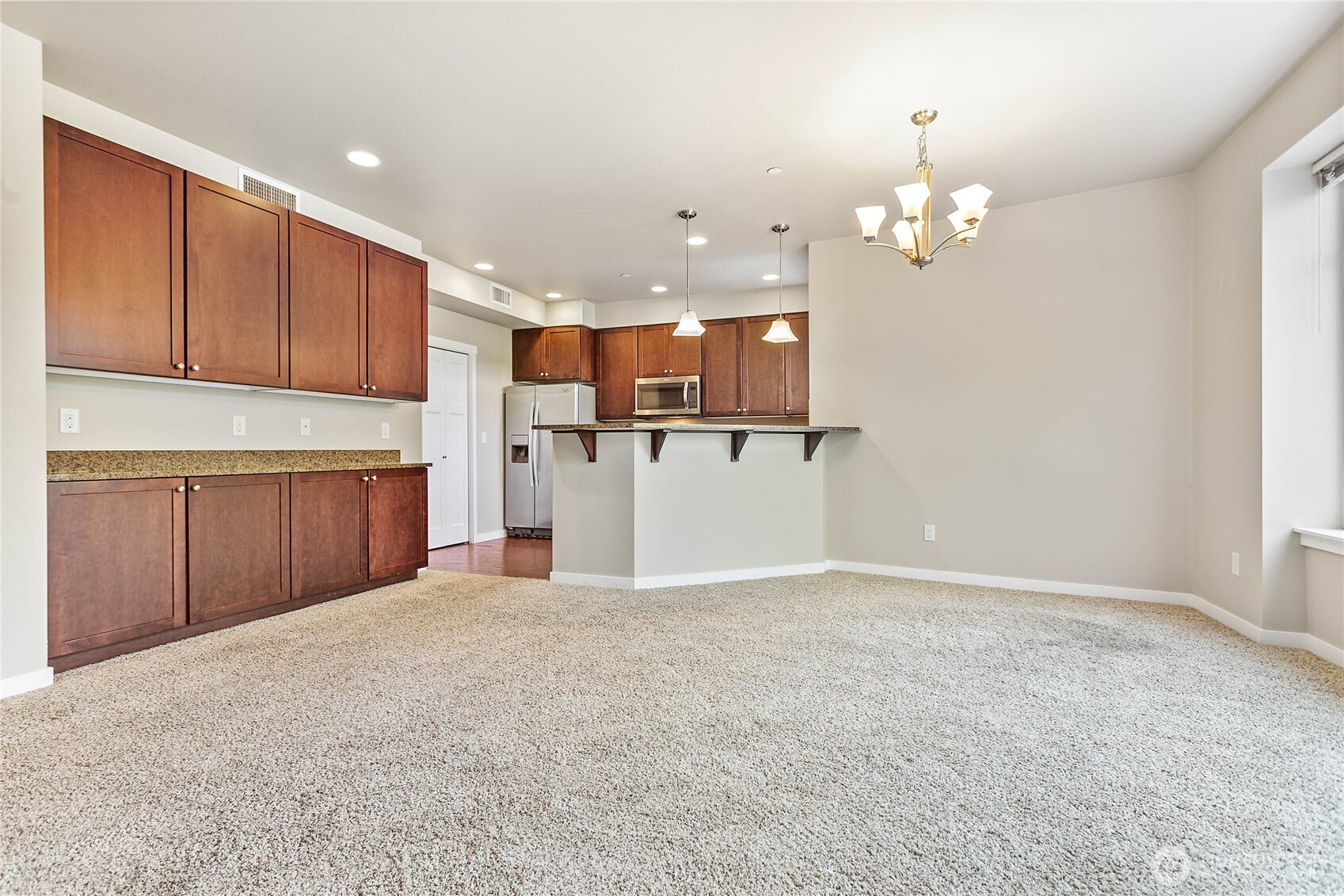 8780 Depot Road, Unit 207 Lynden, WA 98264 - Photo 10 of 37 a view of a kitchen with a sink and chandelier