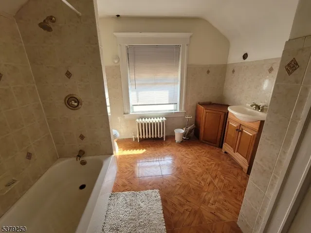 a bathroom with a tub sink and toilet