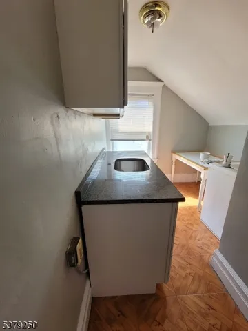 a utility room with sink dryer and washer