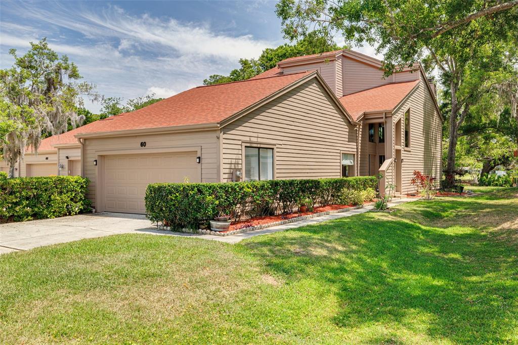 60 Woodridge Circle Oldsmar, FL 34677 - Photo 1 of 1 a front view of a house with a yard