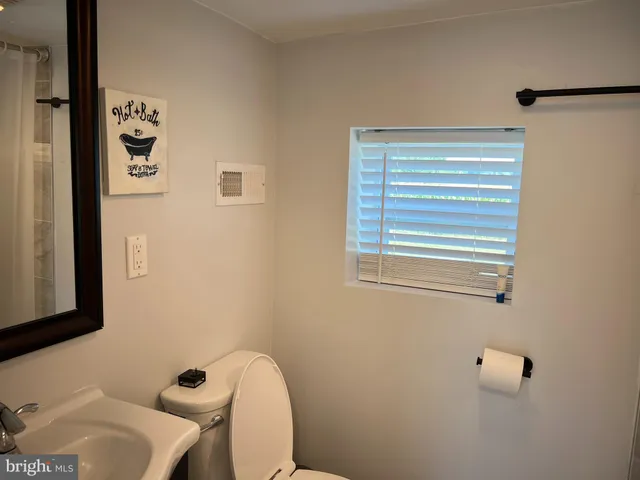 a white toilet sitting next to a bathroom sink