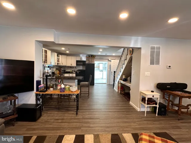 a living room with lots of furniture and a flat screen tv