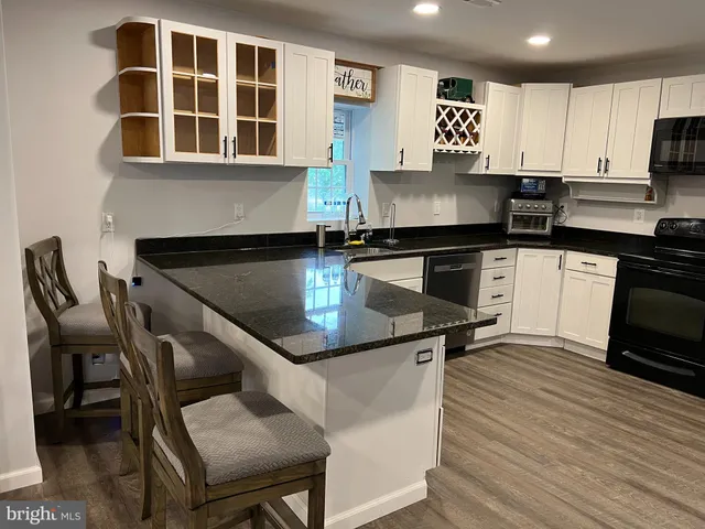 a kitchen with a stove a sink and a microwave