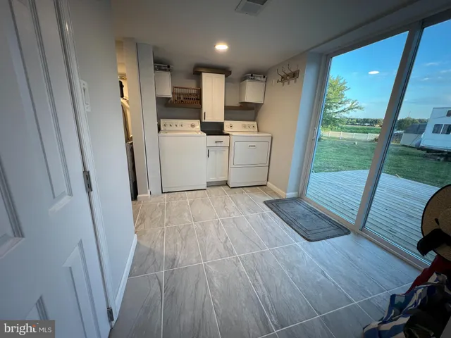a view of a kitchen with wooden floor and a sink