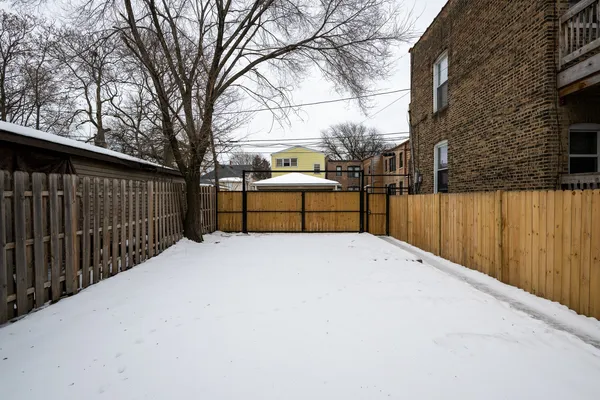 a view of a wooden fence and a bench