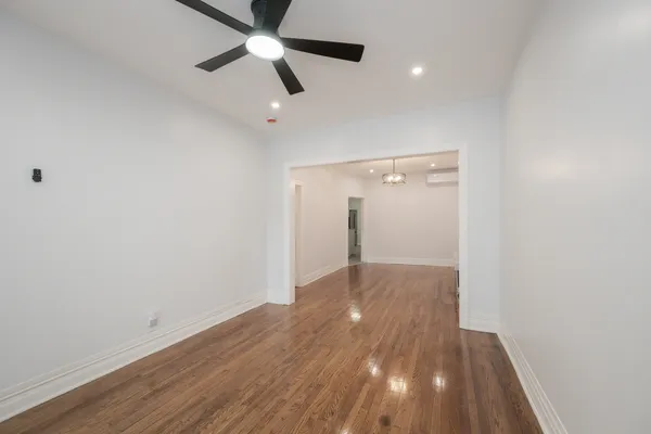 an empty room with wooden floor a ceiling fan and closet