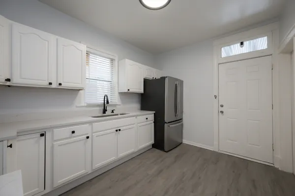 a kitchen with stainless steel appliances granite countertop a refrigerator sink and cabinets