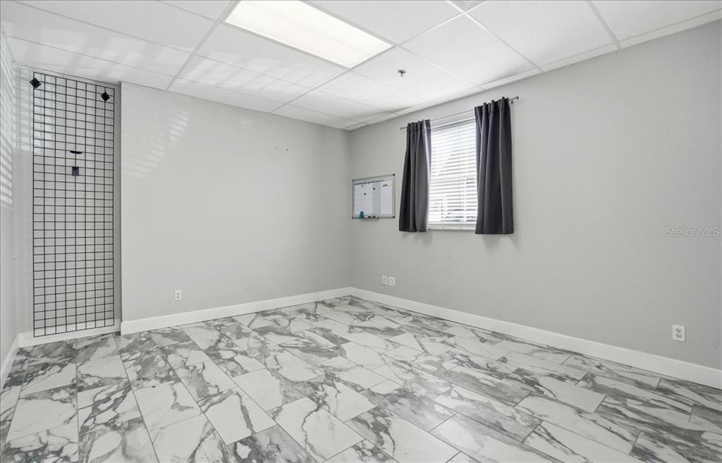 6321 Porter Road, Unit 2 Sarasota, FL 34240 - Photo 8 of 32 a view of empty room with wooden floor and fan