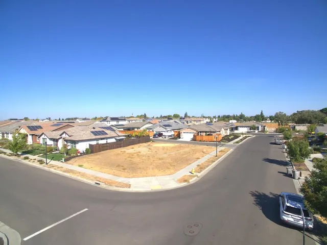 an aerial view of residential houses with a city view