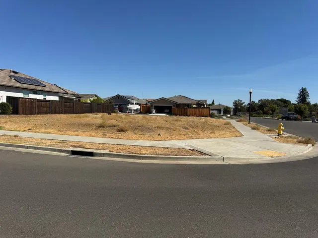 a view of street with a car parked on the road