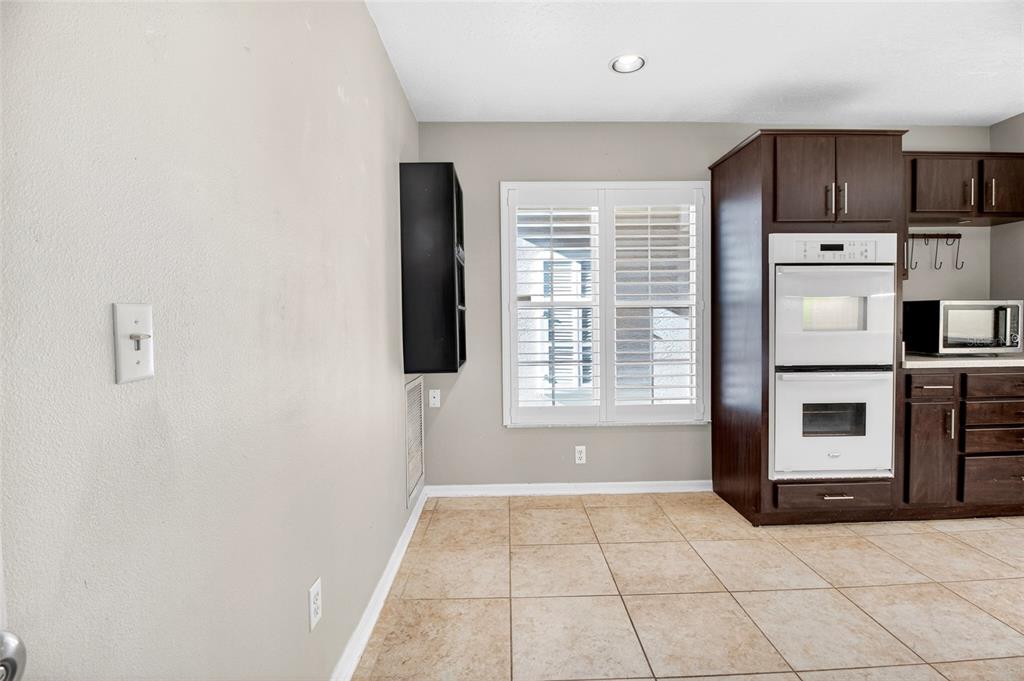 2250 Chase Court Mount Dora, FL 32757 - Photo 12 of 46 a view of kitchen with stainless steel appliances wooden floor and window