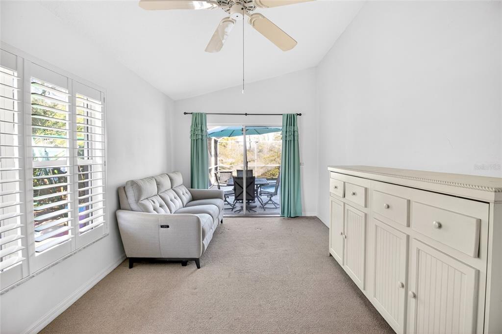 2250 Chase Court Mount Dora, FL 32757 - Photo 20 of 46 a spacious bedroom with a bed and a chandelier