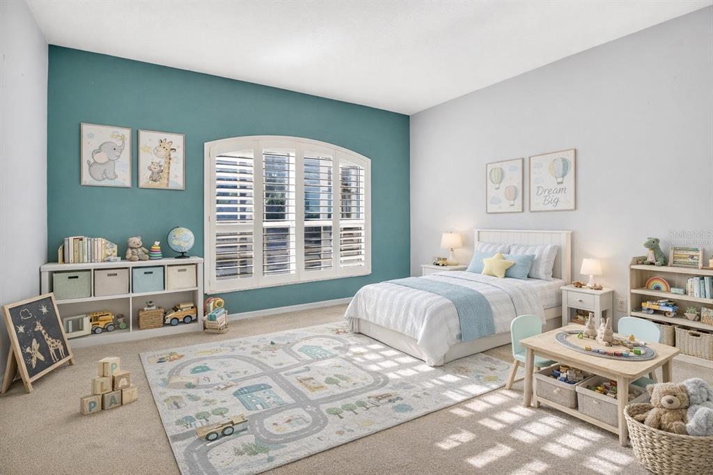 2250 Chase Court Mount Dora, FL 32757 - Photo 21 of 46 a spacious bedroom with a bed a table and a window