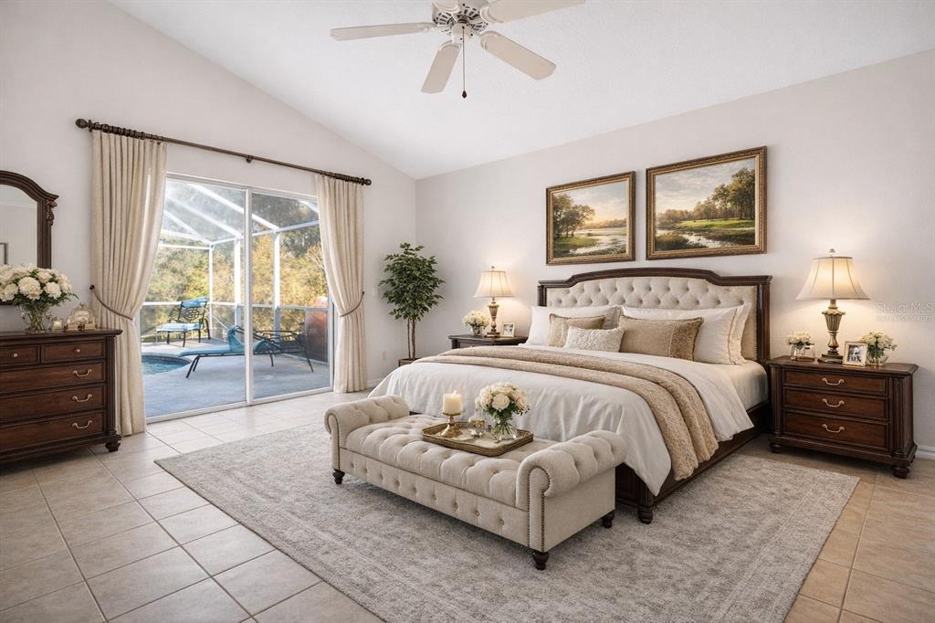 2250 Chase Court Mount Dora, FL 32757 - Photo 24 of 46 a bedroom with a large bed and a chandelier