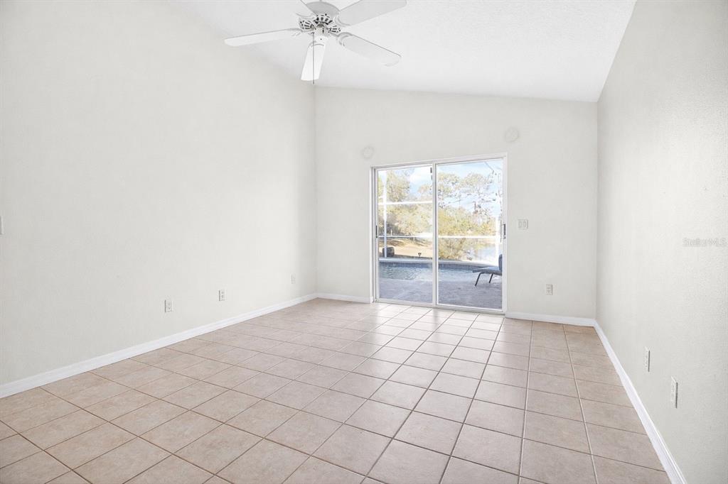 2250 Chase Court Mount Dora, FL 32757 - Photo 27 of 46 an empty room with windows and chandelier fan