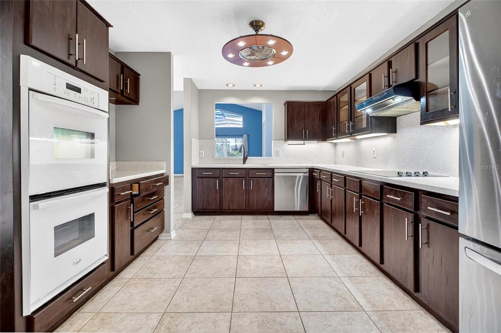 2250 Chase Court Mount Dora, FL 32757 - Photo 8 of 46 a kitchen with stainless steel appliances granite countertop a stove a sink and a refrigerator