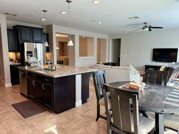 a kitchen with stainless steel appliances kitchen island granite countertop a sink and cabinets