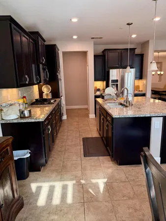 a room with stainless steel appliances a sink a counter top space and a window