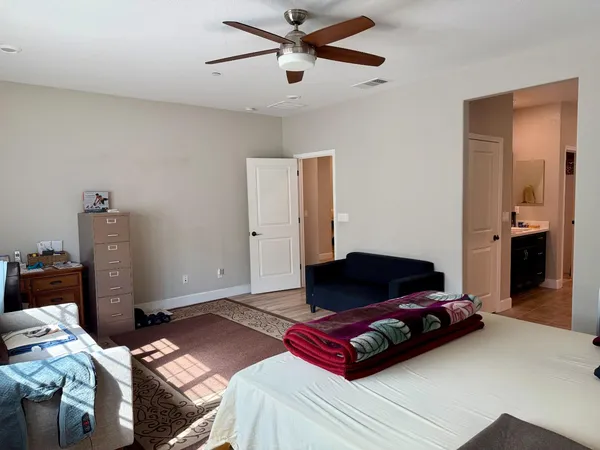a view of bedroom with a bed and a mirror