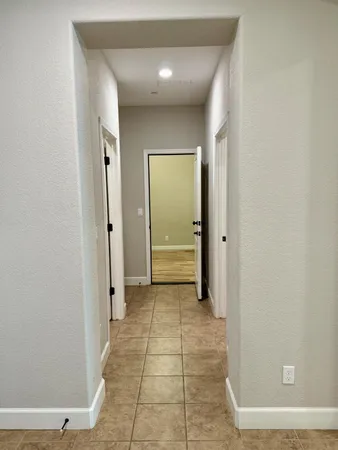 a view of a bedroom with wooden floor and bathroom