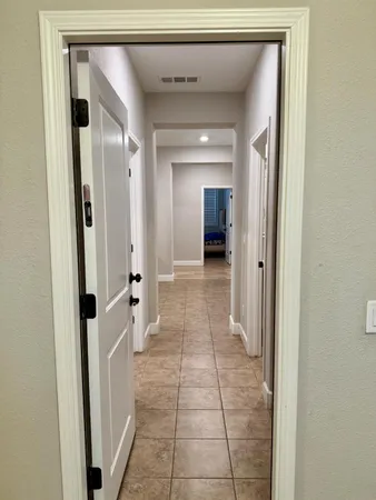 a view of a room with wooden floor and a sink