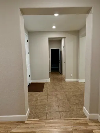 a view of a livingroom with furniture and a gym equipment