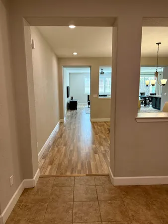 a view of a livingroom with wooden floor and furniture