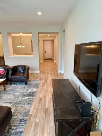 a living room with stainless steel appliances kitchen island granite countertop furniture and a kitchen view