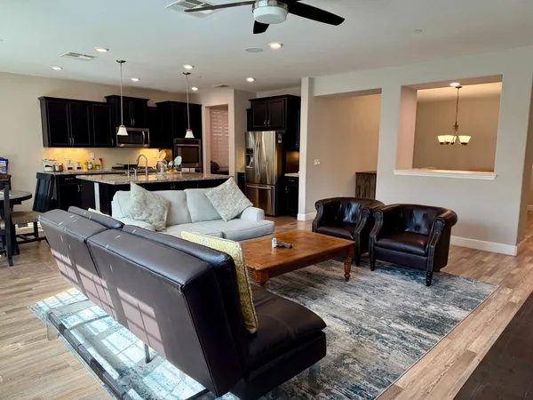 a kitchen with a table chairs refrigerator and microwave