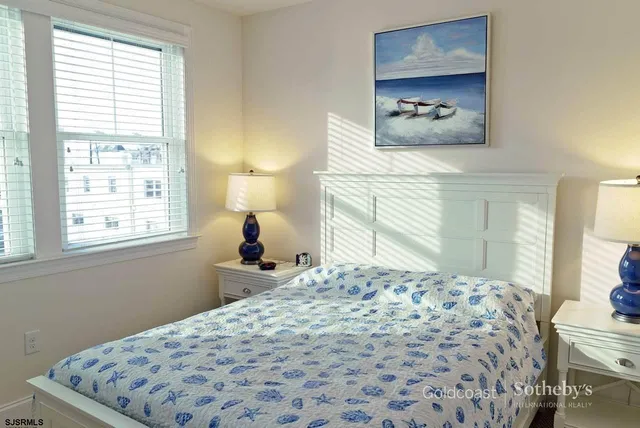 a bedroom with a bed and a flat tv screen in it