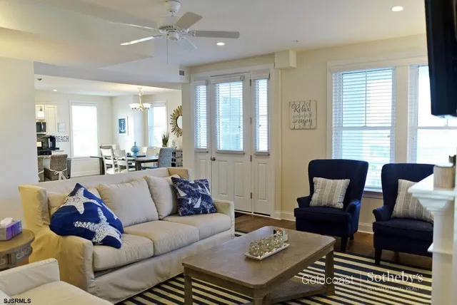 a living room with furniture fireplace and a large window