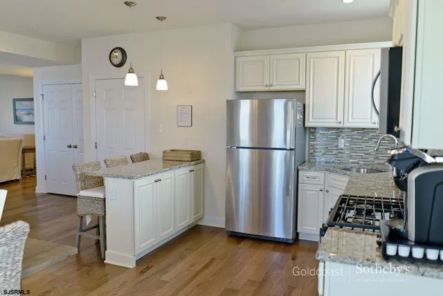 a kitchen with sink a refrigerator and a stove