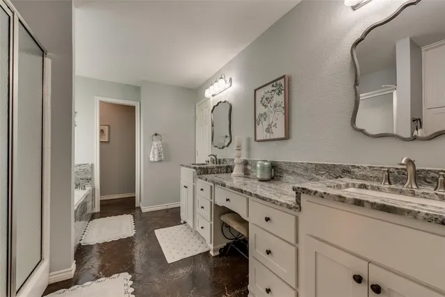 a spacious bathroom with a granite countertop sink and a mirror