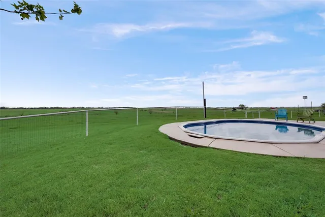 a view of a swimming pool with a yard