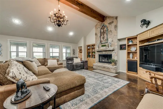 a living room with furniture a fireplace and a flat screen tv