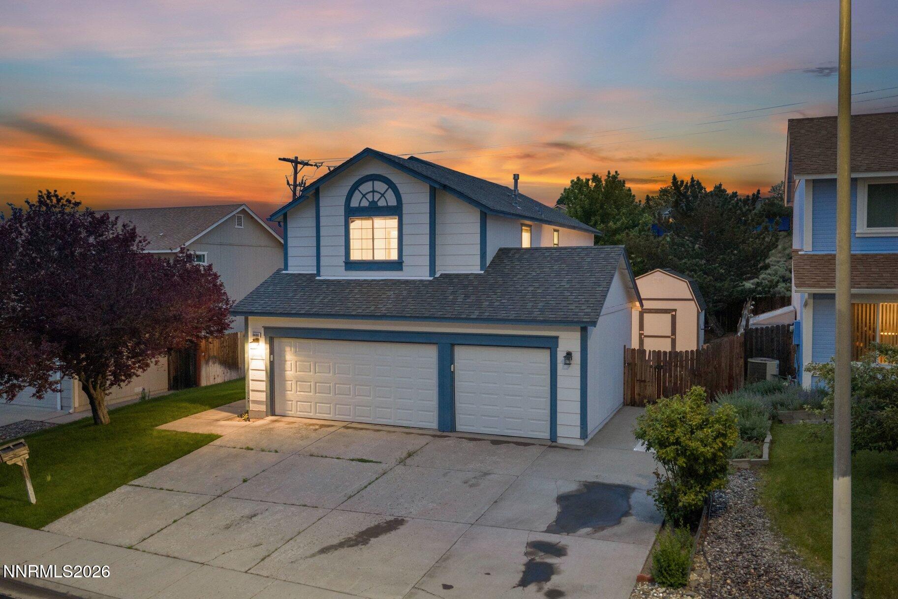 8486 Piper Place Reno, NV 89506 - Photo 78 of 80 a front view of a house with a yard and garage