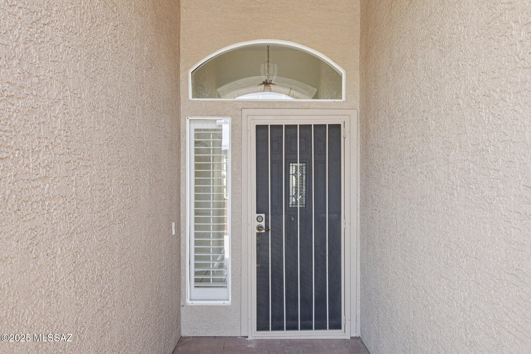 35890 Mesa Ridge Drive Tucson, AZ 85739 - Photo 3 of 31 a view of a hallway with a door