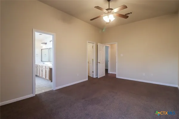 a view of a livingroom with a ceiling fan and window
