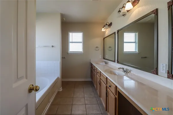 a bathroom with a sink a mirror and a shower