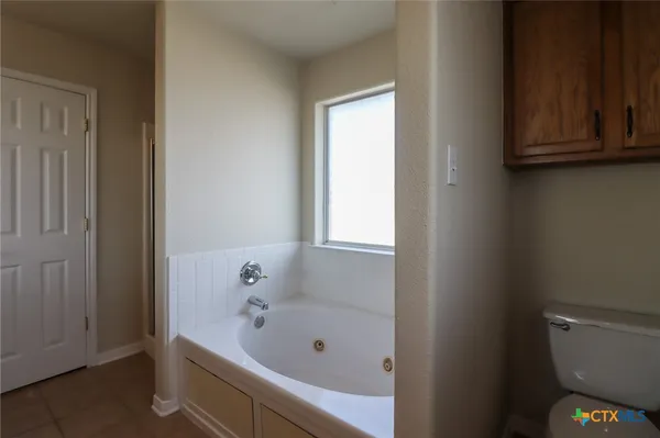 a bathroom with a bathtub and toilet