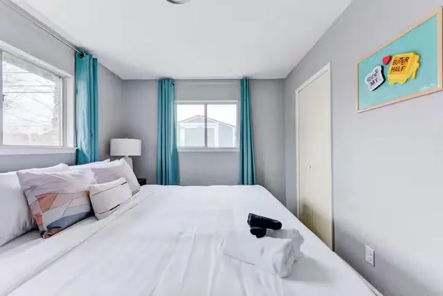 a bed room with two beds and a window